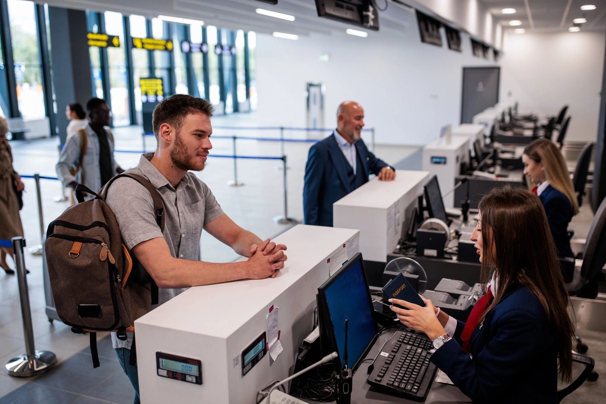 Traveler checking in at a terminal with luggage
