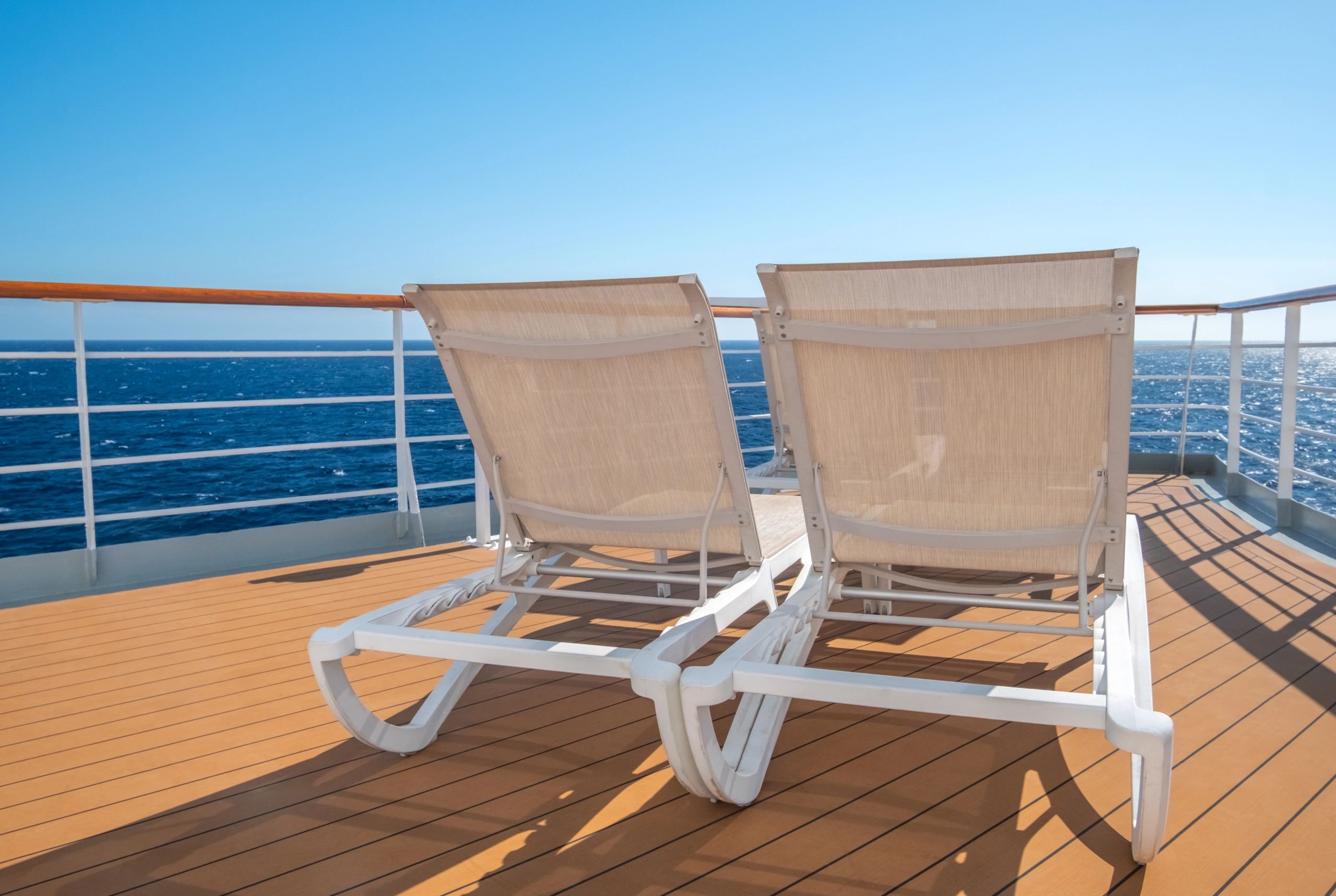 Cruise ship deck with sun loungers and ocean view