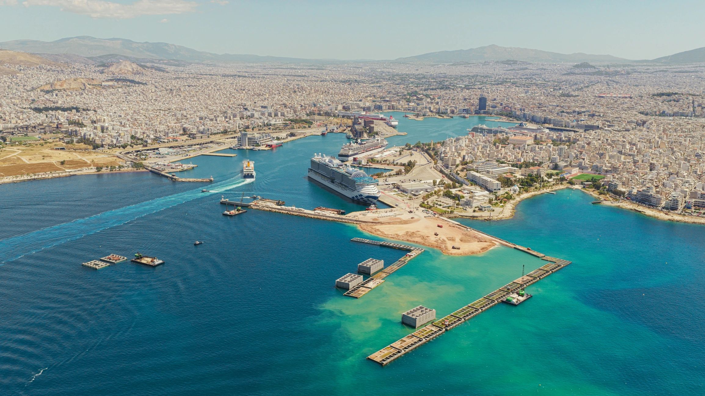 Cruise ships docked beside the blue water at Piraeus port